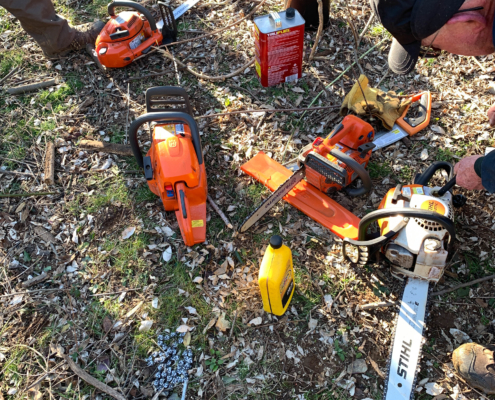 Chainsaws being refueled during an Autumn Olive volunteer day